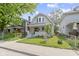 Charming two-story home featuring a well-maintained lawn and inviting front porch at 909 N Parker Ave, Indianapolis, IN 46201