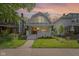 Charming two-story home featuring a well-maintained lawn and inviting front porch with craftsman details at 909 N Parker Ave, Indianapolis, IN 46201