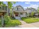 Inviting two-story home with a well-maintained lawn and a charming front porch at 909 N Parker Ave, Indianapolis, IN 46201