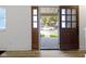 Charming front door with glass panes, looking out from the interior of the home at 909 N Parker Ave, Indianapolis, IN 46201
