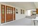 Inviting front porch featuring a wood door, light fixture, and window at 909 N Parker Ave, Indianapolis, IN 46201