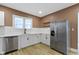 Kitchen featuring white cabinets, stainless steel appliances and hardware, and wood floors at 909 N Parker Ave, Indianapolis, IN 46201