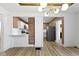 Kitchen and dining area with wood floors and white cabinets at 909 N Parker Ave, Indianapolis, IN 46201
