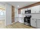 A beautifully updated kitchen with stainless steel appliances and white cabinets at 909 N Parker Ave, Indianapolis, IN 46201