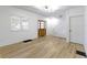 Bright living room featuring wood floors, white walls, natural light, and stairway at 909 N Parker Ave, Indianapolis, IN 46201