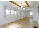 Well-lit living room with wood floors, large windows, and decorative lighting at 909 N Parker Ave, Indianapolis, IN 46201
