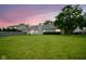 Beautiful backyard with a lush green lawn and a view of the home's exterior at 11418 Geist Valley Dr, Indianapolis, IN 46236