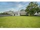 Well-maintained backyard with a lush green lawn, mature tree, and the home's exterior at 11418 Geist Valley Dr, Indianapolis, IN 46236
