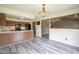 Open concept view of the kitchen and dining room with new wood-look floors at 11418 Geist Valley Dr, Indianapolis, IN 46236