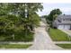 Charming home with a well-manicured lawn, mature trees, and a spacious two car garage at 11418 Geist Valley Dr, Indianapolis, IN 46236