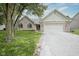 Charming single-Gathering home featuring a two-car garage, brick accents, and well-maintained landscaping at 11418 Geist Valley Dr, Indianapolis, IN 46236
