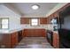 Kitchen featuring classic cabinets, modern appliances, and wood-look flooring at 11418 Geist Valley Dr, Indianapolis, IN 46236