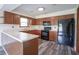 Well-lit kitchen features ample cabinet space, modern appliances, and wood-look floors at 11418 Geist Valley Dr, Indianapolis, IN 46236