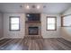 Bright living room with hardwood floors and a brick fireplace, perfect for cozy nights in at 11418 Geist Valley Dr, Indianapolis, IN 46236