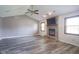 Spacious living room features vaulted ceiling, hardwood floors, and a cozy brick fireplace at 11418 Geist Valley Dr, Indianapolis, IN 46236
