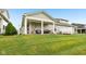 A spacious lawn complements the home's covered patio with outdoor seating and grill at 11429 Lottie Cir, Noblesville, IN 46060