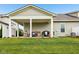 Well-maintained backyard featuring a covered patio with comfortable seating and a grill at 11429 Lottie Cir, Noblesville, IN 46060