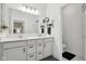 Stylish bathroom with white cabinets, double sinks, quartz countertop and large mirror at 11429 Lottie Cir, Noblesville, IN 46060