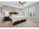 Comfortable bedroom with wood accent wall, ceiling fan and ensuite bathroom and walk-in closet at 11429 Lottie Cir, Noblesville, IN 46060