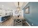 A stylish dining room featuring a rustic table, modern pendant lighting, and a large decorative mirror at 11429 Lottie Cir, Noblesville, IN 46060