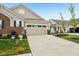 A well-lit two-car garage with a spacious driveway and neat landscaping at 11429 Lottie Cir, Noblesville, IN 46060