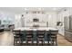 Bright, open kitchen featuring a large island, stylish barstools, and stainless steel appliances at 11429 Lottie Cir, Noblesville, IN 46060