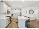 A modern kitchen with white cabinetry, stainless steel appliances and island with breakfast bar seating at 11429 Lottie Cir, Noblesville, IN 46060