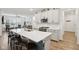 Kitchen with island featuring sink and breakfast bar facing an open-concept living area at 11429 Lottie Cir, Noblesville, IN 46060