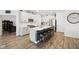 A kitchen featuring a central island with barstool seating, white cabinets, and stainless steel appliances at 11429 Lottie Cir, Noblesville, IN 46060