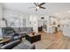 Open-concept living room with hardwood floors, offering great views of the kitchen and dining area at 11429 Lottie Cir, Noblesville, IN 46060
