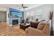 Cozy living room with a fireplace, hardwood floors, and plenty of natural light at 11429 Lottie Cir, Noblesville, IN 46060