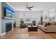 Comfortable living room features a fireplace, large windows, hardwood floors, and neutral decor at 11429 Lottie Cir, Noblesville, IN 46060