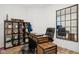Office space featuring a modern desk, black leather chair and industrial-style shelving unit at 11429 Lottie Cir, Noblesville, IN 46060