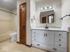 Well-lit bathroom featuring a modern vanity with sleek hardware and a framed mirror at 1205 Cypress Dr, Shelbyville, IN 46176