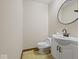 A small bathroom has a toilet and a vanity with a sink at 1205 Cypress Dr, Shelbyville, IN 46176