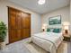 A staged bedroom with a carpet, closet, and bed at 1205 Cypress Dr, Shelbyville, IN 46176