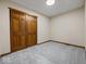A carpeted bedroom has a closet with sliding wood doors at 1205 Cypress Dr, Shelbyville, IN 46176