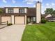Inviting townhome with attached two-car garage and well-manicured lawn at 1205 Cypress Dr, Shelbyville, IN 46176