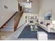 Bright living room with high ceilings, staircase, and modern furniture at 1205 Cypress Dr, Shelbyville, IN 46176