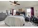 This spacious bedroom features a ceiling fan, two windows, and a work desk at 1255 Crabapple Rd, Franklin, IN 46131