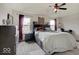 This cozy bedroom features a ceiling fan, dresser, and large bed with storage at 1255 Crabapple Rd, Franklin, IN 46131