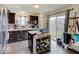 Well-lit kitchen features dark wood cabinets, stainless steel appliances, and sliding door access to backyard at 1255 Crabapple Rd, Franklin, IN 46131