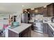 Open kitchen features stainless steel appliances, a center island, and dark wood cabinets at 1255 Crabapple Rd, Franklin, IN 46131