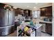 This modern kitchen features stainless steel appliances, dark wood cabinets, and a center island with breakfast bar at 1255 Crabapple Rd, Franklin, IN 46131