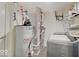 Functional laundry room with a washer, dryer, and water heater at 1255 Crabapple Rd, Franklin, IN 46131