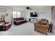 Bright living room with neutral carpet, large windows, a ceiling fan, and comfortable seating at 1255 Crabapple Rd, Franklin, IN 46131