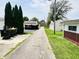 Photo of a paved alleyway bordered by grassy yards and utilities at 128 E 36Th St, Anderson, IN 46013