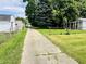 View of a shared driveway with green grass on each side at 128 E 36Th St, Anderson, IN 46013