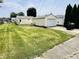 Wide backyard showing the home, a detached garage, and lush green lawn at 128 E 36Th St, Anderson, IN 46013