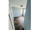 This quaint bedroom features dark flooring, fresh paint, and two bright windows at 128 E 36Th St, Anderson, IN 46013
